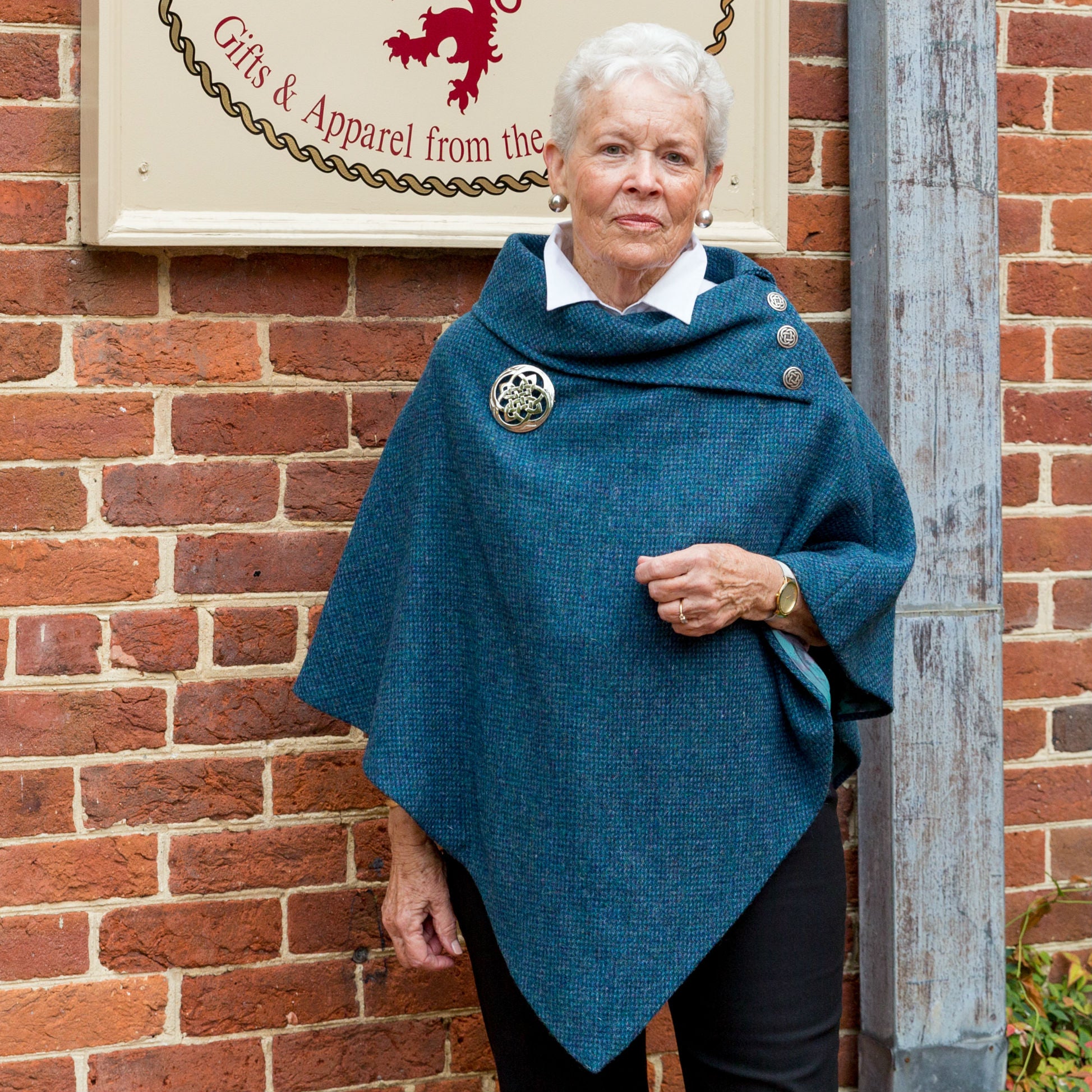 women's teal Harris Tweed poncho with metal Celtic buttons